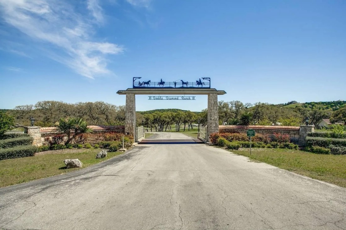 Stone entrance gate to Double Diamond Ranch with iron horse silhouettes